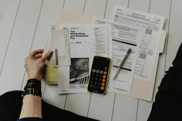 Quotation documents, a calculator and notes on a desk