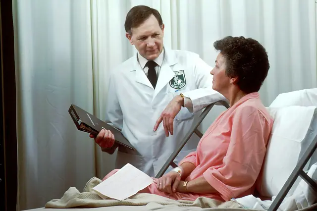 A doctor explaining information to a patient at the bedside
