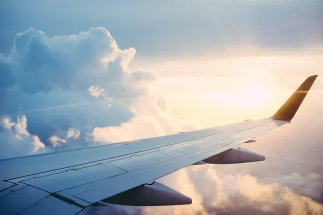 Clouds seen from an airplane wing during a journey